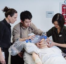 Clinician teaching medical students using a simulation mannequin